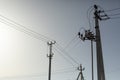 Lots of poles with wires. Electrical wires against sky. Radio communication towers. Royalty Free Stock Photo