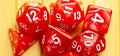 Lots of red RPG game dice extreme closeup wide shot, banner. Role playing board games symbol, simple polyhedral dice set scattered Royalty Free Stock Photo