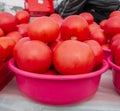 Lots of red tomatoes in plastic on the counter. Sale of tomatoes at the farmers\' market. Close-up. Red ripe tomatoes Royalty Free Stock Photo