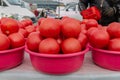 Lots of red tomatoes in plastic on the counter. Sale of tomatoes at the farmers\' market. Red ripe tomatoes Royalty Free Stock Photo