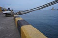 Lots of rope knots leading to moored ships. Boat ropes, ship. Mooring post on the waterfront , element for mooring ships