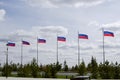 Lots of Russian flags against the sky in the park on a summer day Royalty Free Stock Photo