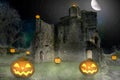 Scary halloween pumpkin lanterns in front of an old castle at night Royalty Free Stock Photo