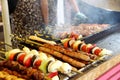 lots of skewers of pork, lamb, grilled kebabs of lamb and skewer of fresh vegetables. concept of street fast food Royalty Free Stock Photo