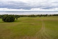 Lots of sky. Landscape overlooking fields, meadows, clouds and a lake.