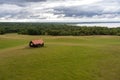 Lots of sky. Landscape overlooking fields, meadows, clouds and a lake.