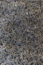 Lots of small black screws. Texture, bunch of screws scattered around. screws texture background Royalty Free Stock Photo
