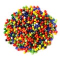 Lots of small, multi-colored glass beads, isolated on a white background Royalty Free Stock Photo