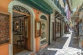 lots of small stalls and walking tourists give the atmosphere of the streets of the capital of corfu in greece