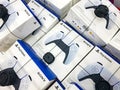 Lots of Sony Playstation 5 PS5 video game console DualSense wireless controllers on sale, multiple game pads packaged at the store