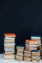 Lots of stacks of old educational books on black background library Royalty Free Stock Photo