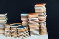 Lots of stacks of old educational books on black background library Royalty Free Stock Photo