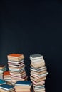 Lots of stacks of old educational books on black background library Royalty Free Stock Photo