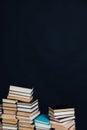 Lots of stacks of old educational books on black background library Royalty Free Stock Photo