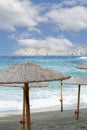 Lots of straw umbrellas on a tropical beach in the sunny day. Ocean shore and sandy coastline Royalty Free Stock Photo