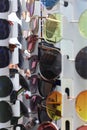 Lots of Sunglasses on the street stand in Heidelberg, Germany. Group of colourful sunglasses on the shelf of the optical shop.