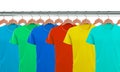 Lots of T-shirts on hangers isolated on white Royalty Free Stock Photo