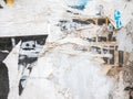 Lots of torn damaged paper posters, adverts, scraped off advertisements on a building wall, abstract creative background texture Royalty Free Stock Photo
