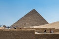Lots of tourists visiting the Pyramid of Khufu in The Giza pyramid complex, an archaeological site on the Giza Plateau, on the