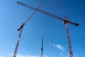 Lots of tower onstruction site with cranes and building with blue sky background
