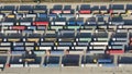 Lots of trucks in the port terminal. Top view of loaded containers and tractor trailers.