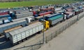 Lots of trucks with trailers in the parking lot. Queue for unloading at the port