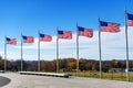 Lots of united states flags against a blue sky, at the base of George Washington Memorial in Washington D.C Royalty Free Stock Photo