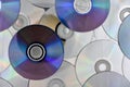 Lots of used laser CDs and DVDs on the surface of the table, technological background Royalty Free Stock Photo