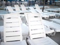 Lots of white empty sun loungers at the pool closeup at sunset Royalty Free Stock Photo