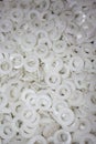 Lots of white plain friction bearings as parts of a final product plastic industry production