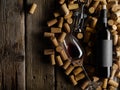 Lots of wine corks, a bottle of red wine, a wine glass and a corkscrew. Isolated on a wooden background. Low angle view. There is Royalty Free Stock Photo