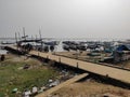 Lots of wooden fishing boats anchored near the shore and jetty in the salt Lake. Royalty Free Stock Photo