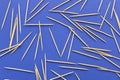 Lots of wooden toothpicks on a blue background. The concept of order and chaos