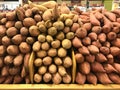 Yams and sweet potatoes stacked up at the market
