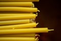 Lots of yellow candles on a dark background. Royalty Free Stock Photo