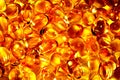 Lots of yellow red capsules, golden oil fish omega 3 capsules- Omega