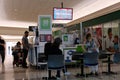 lottery draw winning people stand near a lottery kiosk in a large Mall trying to win. person in a wheelchair, women, men