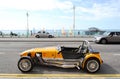 Lotus Cobra car parked in the Brighton beach avenue with old West Pier in background. Royalty Free Stock Photo