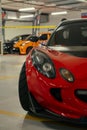 Lotus Elise in red being display at a car show.