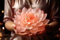 Lotus flower in the hands of a woman close-up