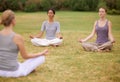 Lotus, group and meditation outdoor for yoga, healthy body and mindfulness exercise to relax. Peace, zen and calm women