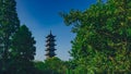 Lotus Tower between trees under blue sky in the old town of Wuzhen, China Royalty Free Stock Photo