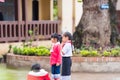 LOUANGPHABANG, LAOS - JANUARY 11, 2017: Children in the school yard. Copy space for text. Close-up. Royalty Free Stock Photo