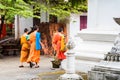 LOUANGPHABANG, LAOS - JANUARY 11, 2017: Group of monks on a city street. Copy space for text. Royalty Free Stock Photo