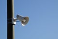 Loud speaker on pole against blue sky Royalty Free Stock Photo