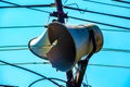 Loud Speaker or vintage white horn speaker on the pole. For public relations in the community. With wires, cables and blue skies Royalty Free Stock Photo