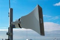 Loudspeaker of the emergency warning system against the background of a blue sky Royalty Free Stock Photo