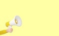 loudspeaker - human hand holding yellow megaphone banner with empty space for text Royalty Free Stock Photo
