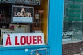 A Louer For Rent in French signs behind store windows during Covid-19 pandemic