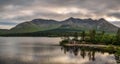 Lough Inagh in Ireland with a cabin and boats at the lake shore